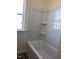 A new bathtub in bathroom with three storage shelves on the wall at 65 Vili Dr, Broadway, NC 27505