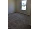 Carpeted bedroom with a large window and natural light at 65 Vili Dr, Broadway, NC 27505