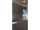 Well-lit bedroom with plush carpeting and a large window offering ample natural light at 65 Vili Dr, Broadway, NC 27505