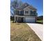 Two-story home featuring a two-car garage and neutral siding, located on a grassy lawn at 65 Vili Dr, Broadway, NC 27505