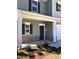 Covered front porch with classic columns and brick accents at 65 Vili Dr, Broadway, NC 27505