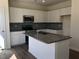This spacious kitchen features an island, stainless steel appliances and white cabinets at 65 Vili Dr, Broadway, NC 27505