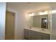 Double vanity bathroom with modern finishes and a large mirror at 68 Hampshire Ct, Four Oaks, NC 27524