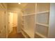 Hallway with built-in shelves and a half bathroom at 68 Hampshire Ct, Four Oaks, NC 27524