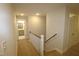 Upstairs hallway with a staircase and doors to bedrooms at 68 Hampshire Ct, Four Oaks, NC 27524