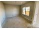 Spacious living room with neutral walls and large windows, currently under construction at 71 Victory View W Ter, Smithfield, NC 27577