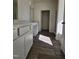 Bathroom featuring wood-look floors, white cabinets and marble counters at 87 Vili Dr, Broadway, NC 27505