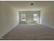 Spacious bedroom featuring plush carpeting and natural light from large windows at 87 Vili Dr, Broadway, NC 27505