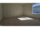 Bright bedroom with plush carpet, a window, and a door at 87 Vili Dr, Broadway, NC 27505