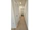 Hallway view showing wood-look floors and a laundry room at the end at 87 Vili Dr, Broadway, NC 27505