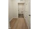 Hallway view showing wood-look floors and a laundry room at the end at 87 Vili Dr, Broadway, NC 27505