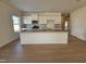 Open-concept kitchen with a large island, white cabinets, granite counters and stainless appliances at 87 Vili Dr, Broadway, NC 27505