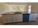 Bright, open kitchen featuring a central island, stainless steel sink, and modern appliances at 87 Vili Dr, Broadway, NC 27505