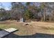 Large backyard with storage shed and wooded area at 909 E F St, Butner, NC 27509