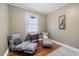 Cozy bedroom with hardwood floors and seating area at 909 E F St, Butner, NC 27509