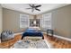 Bright bedroom with a blue bedspread and hardwood floors at 909 E F St, Butner, NC 27509