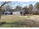 Gray house with a wooden porch and landscaped yard at 909 E F St, Butner, NC 27509