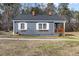 Gray house with white trim and a wooden porch at 909 E F St, Butner, NC 27509