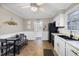 Updated kitchen with white cabinets and black appliances at 909 E F St, Butner, NC 27509