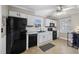 Modern kitchen with black appliances and white cabinets at 909 E F St, Butner, NC 27509