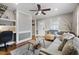 Cozy living room features a comfy couch, wood floors and built-in shelving at 909 E F St, Butner, NC 27509