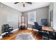 Bright office with wood desk and window views at 909 E F St, Butner, NC 27509