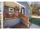 Wooden porch with seating and a ceiling fan at 909 E F St, Butner, NC 27509
