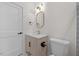 Stylish bathroom featuring a light vanity, gold fixtures, and a large mirror at 101 Prairie Dog Dr, Louisburg, NC 27549