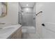 Modern bathroom with gray tile, a glass shower, and updated vanity at 101 Prairie Dog Dr, Louisburg, NC 27549