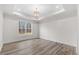 Spacious bedroom with wood-look floors and large window at 101 Prairie Dog Dr, Louisburg, NC 27549