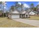 Two-car garage with a light-colored exterior and a neatly manicured lawn at 101 Prairie Dog Dr, Louisburg, NC 27549