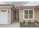 Front entrance with a wooden door and stone exterior at 101 Prairie Dog Dr, Louisburg, NC 27549