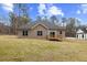 Rear view of a charming house with gray siding and a deck at 101 Prairie Dog Dr, Louisburg, NC 27549
