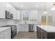 Modern kitchen, white cabinets, herringbone backsplash, island at 101 Prairie Dog Dr, Louisburg, NC 27549
