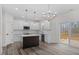 Modern kitchen with island, white cabinets, and stainless steel appliances at 101 Prairie Dog Dr, Louisburg, NC 27549