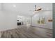 Bright living room, hardwood floors, kitchen access, backyard view at 101 Prairie Dog Dr, Louisburg, NC 27549
