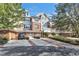 Exterior view of townhome with attached garage and landscaping, car parked in driveway at 10400 Rosegate Ct # 303, Raleigh, NC 27617