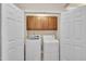 Convenient laundry room with washer, dryer, and overhead cabinets at 10400 Rosegate Ct # 303, Raleigh, NC 27617