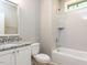 Clean bathroom featuring a white vanity with granite countertop, subway tile shower and modern fixtures at 108 Bearwallow Forest Way, Wendell, NC 27591