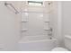 White bathroom with built-in shower, white tile walls, and white toilet at 108 Bearwallow Forest Way, Wendell, NC 27591