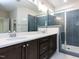 Bathroom with double vanity, quartz countertop, and tiled walk-in shower at 108 Bearwallow Forest Way, Wendell, NC 27591