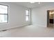 Bedroom with neutral carpet, two windows, and an en suite bathroom at 108 Bearwallow Forest Way, Wendell, NC 27591