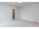 Empty bedroom with carpet, two windows, and a door leading to a closet at 108 Bearwallow Forest Way, Wendell, NC 27591