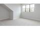 Bedroom with neutral carpet, white walls, and a large window at 108 Bearwallow Forest Way, Wendell, NC 27591