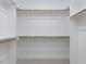 White closet featuring white shelving and bars for hanging clothes at 108 Bearwallow Forest Way, Wendell, NC 27591