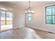Dining room with a modern chandelier and sliding glass doors to the outside deck at 108 Bearwallow Forest Way, Wendell, NC 27591