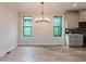 Dining room with modern chandelier and view of the kitchen at 108 Bearwallow Forest Way, Wendell, NC 27591