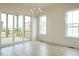 Bright dining room with hardwood floors, sliding glass doors to deck, and a modern chandelier at 108 Bearwallow Forest Way, Wendell, NC 27591