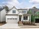 Attractive two-story home with a covered front porch, attached garage, and a well-maintained lawn at 108 Bearwallow Forest Way, Wendell, NC 27591