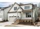 Charming two-story home featuring an attached garage and a welcoming brick staircase leading to the front porch at 108 Bearwallow Forest Way, Wendell, NC 27591